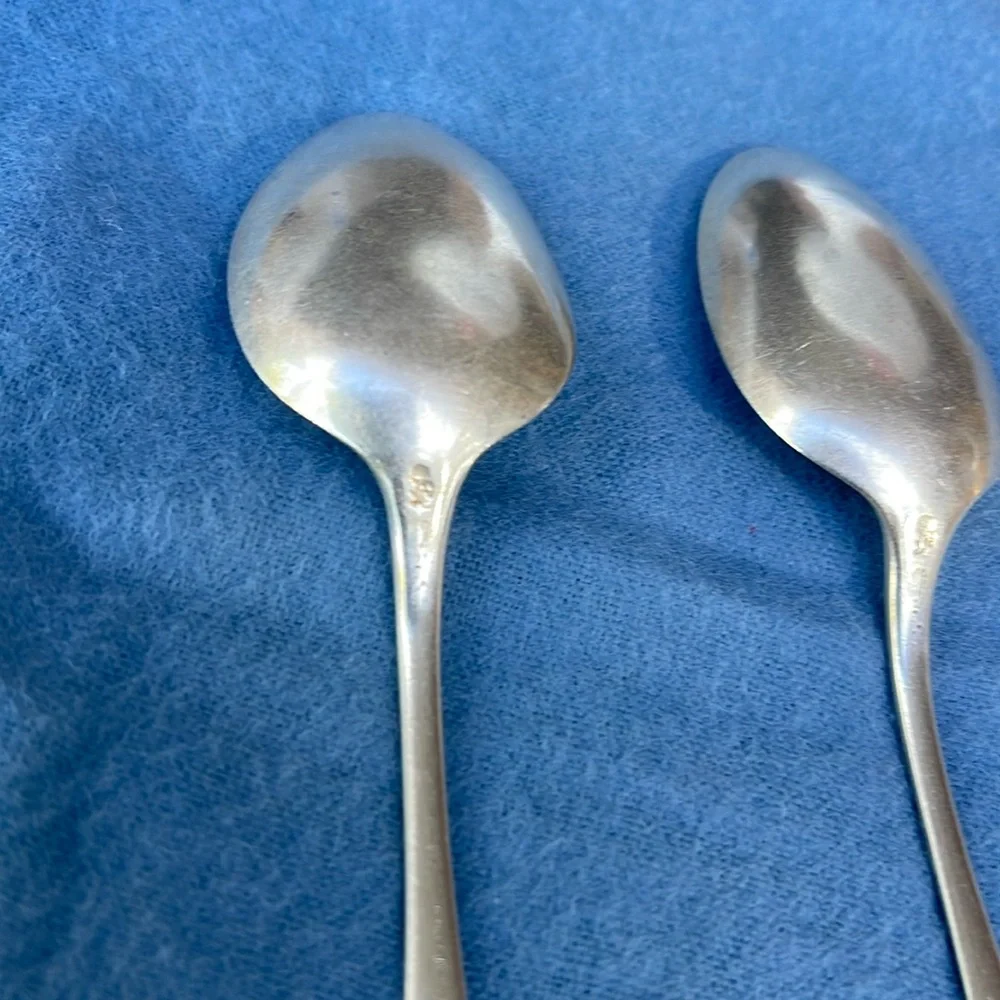 Set of 2 antique spoons , stamped lion and sterling